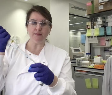 Lindsay Baker in the lab with a pipette Lindsay Baker in the lab with a pipette