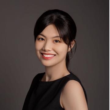 A woman smiles into the camera
