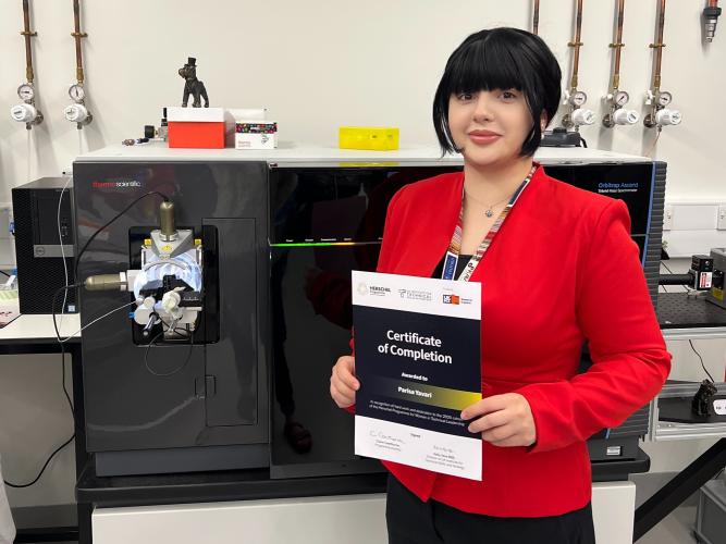 A photo of Parisa Yavari with her certificate of completion