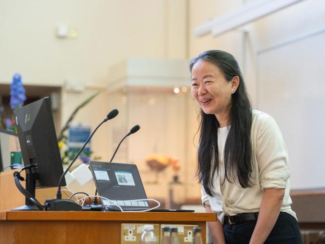 Professor Jue Chen smiling at the podium while delivering her lecture at the Kavli Oxford Lecture Award 2026