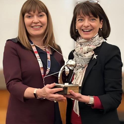 a photo of carol and regina with the award