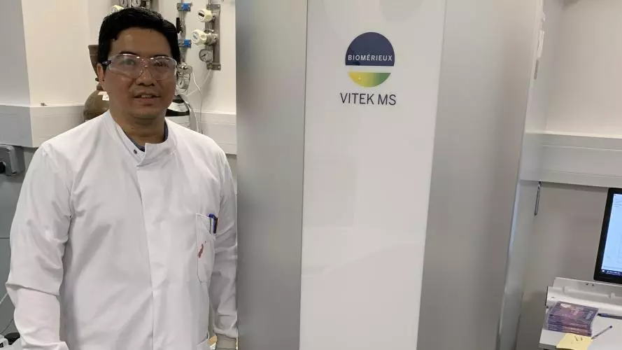 lead author and dphil student yohan arman next to the biomerieux vitek ms used in this study