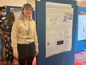 A photograph of Bethan Cole with her poster.