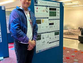 A photograph of Benedict Tanudjojo with his poster.