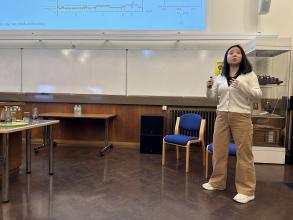A photo of Yujia Qing presenting.