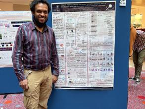 A photograph of Bevin Gangadharan with his poster.