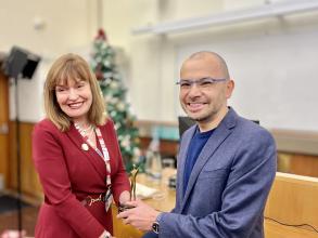 Demis Hassabis receiving his award from Professor Dame Carol Robinson.