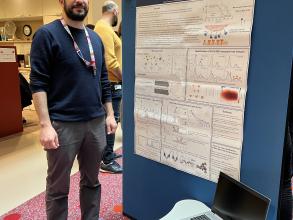 A photograph of Roi Asor with his poster.