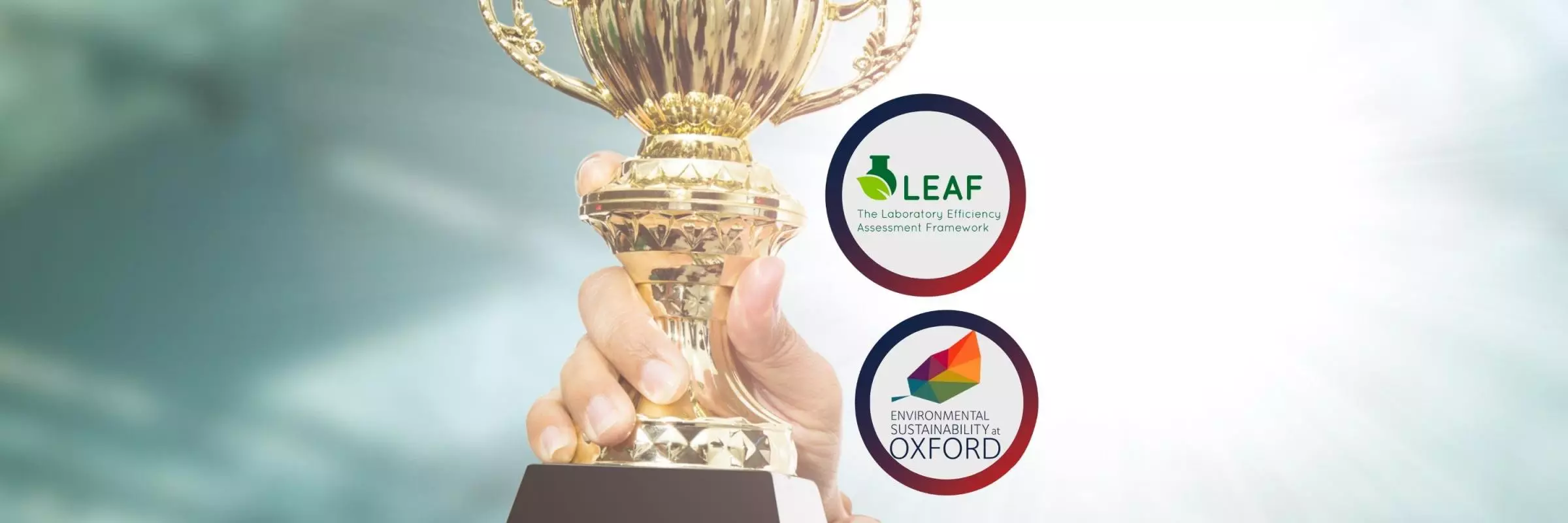 An image with "leaf awards logo" and "environmental sustainability in Oxford logo" in front of a background with hands holding a golden award.